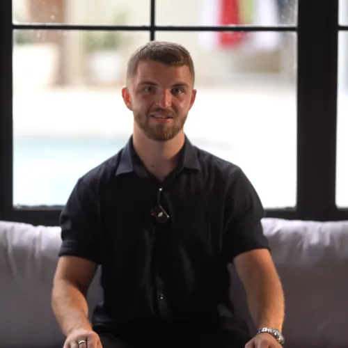 Connor Blades, Founder and Director at Bullseye Properties, a bearded man in a dark shirt sitting in front of a window.